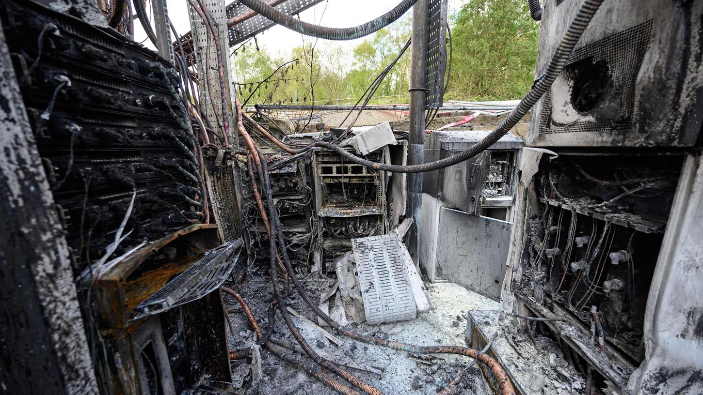 Damaged cabling and telecommunications equipment is pictured following a fire at a phone mast, attatched to the chimney at the converted Fearnleys Mill residential apartment block complex in Huddersfield, northern England, on April 17, 2020. - It is not yet known what caused the mast, which is attached to a chimney at the Fearnleys Mill development, to go up in flames. But the fire comes after a number of mobile phone masts have been set on fire amid claims of a link between 5G and the novel coronavirus COVID-19. (Photo by Oli SCARFF / AFP)