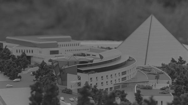 1998/99 plant man eine Erweiterung: Der Neubau hinter dem Flachbau bekommt die Form eines auf dem Kopf stehenden Kegels oder einer "Kaffeetasse" und wird über Tunnel angebunden. Das Gelände soll sich in einen Gesundheitspark verwandeln, mit einer 1,5 Meter langen Joggingbahn. Die Autos werden in eine Tiefgarage verbannt.