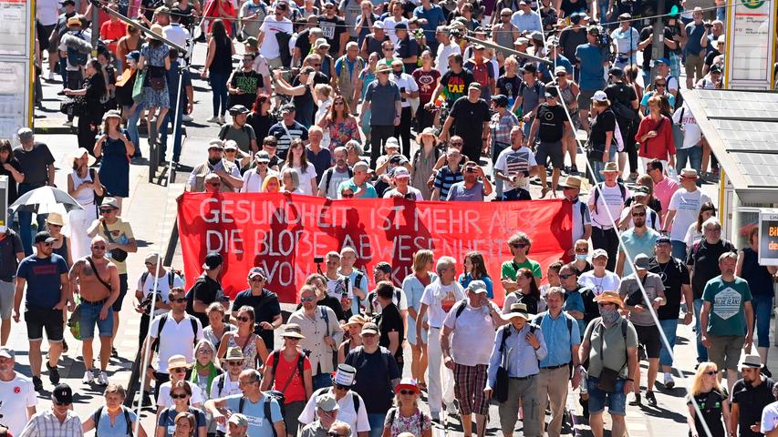 People attend a demonstration of initiated by the initiative "Querdenken-711" with the slogan "the end of the pandemic-the day of freedom" to protest against the current measurements to curb the COVID-19 spreading in Berlin, on August 1, 2020. (Photo by John MACDOUGALL / AFP)