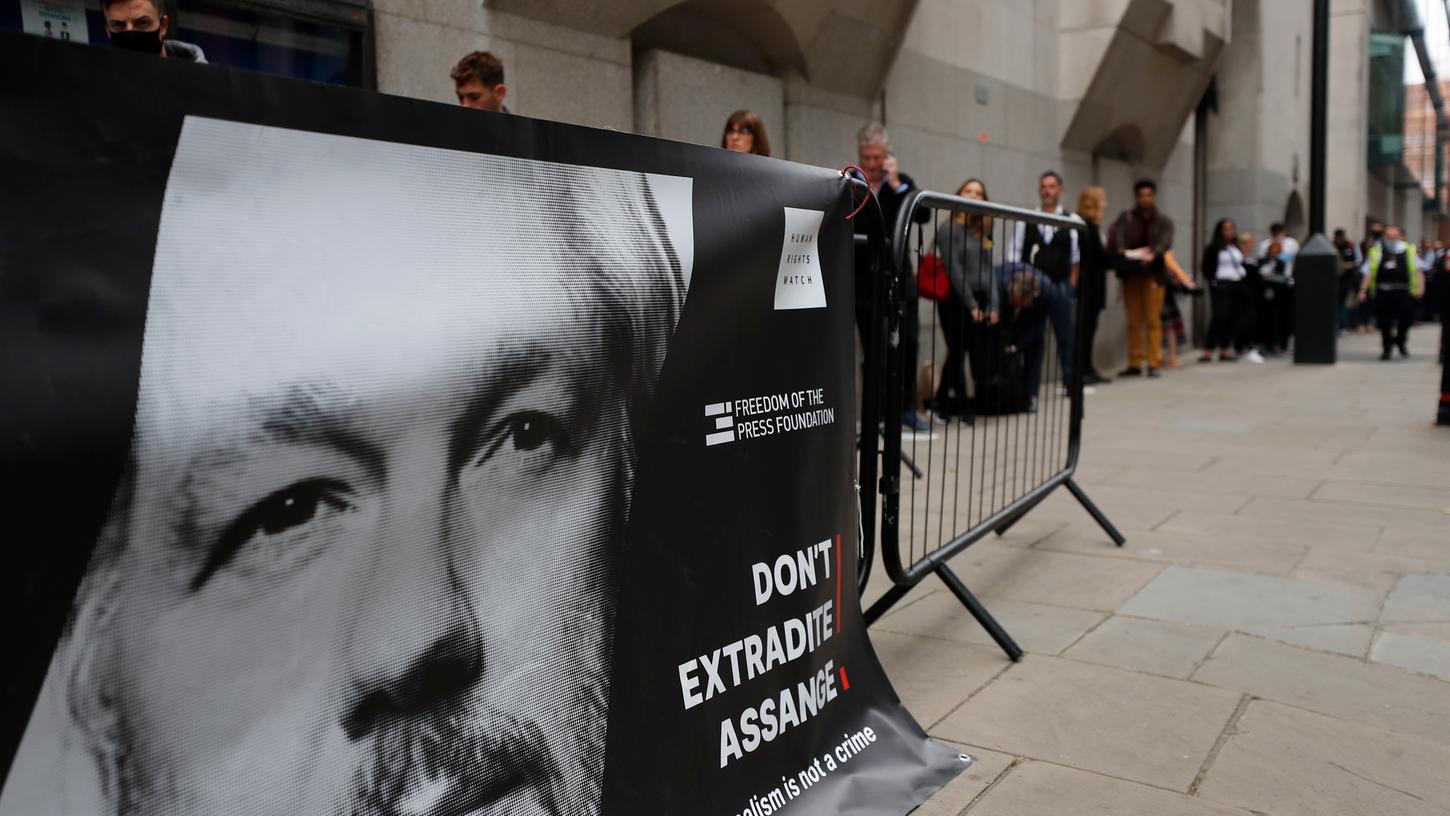Besucher stehen vor dem zentralen Gerichtshof in London Schlange hinter einer Absperrung, an der ein Transparent mit einer Abbildung des WikiLeaks-Gründers Assange und der Aufschrift "Don't Extradite Assange" ("Liefert Assange nicht aus") angebracht ist.