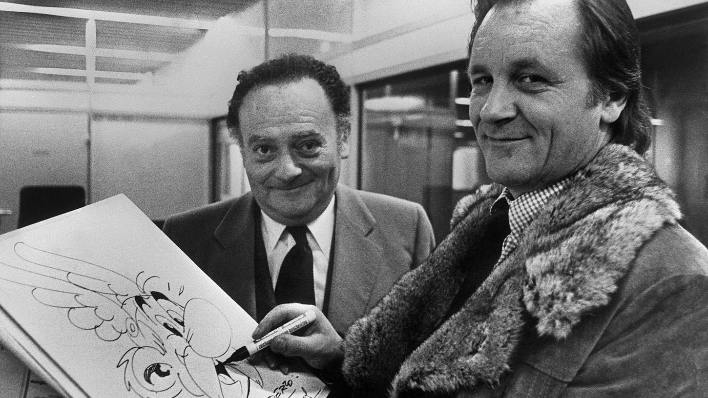 "Der goldene Hinkelstein" trägt noch die Handschrift der beiden Asterix-Väter Albert Uderzo (re.) und René Goscinny (li.), denn die Story wurde bereits 1967 in Frankreich als Bilderbuch zu einem Hörspiel veröffentlicht.
