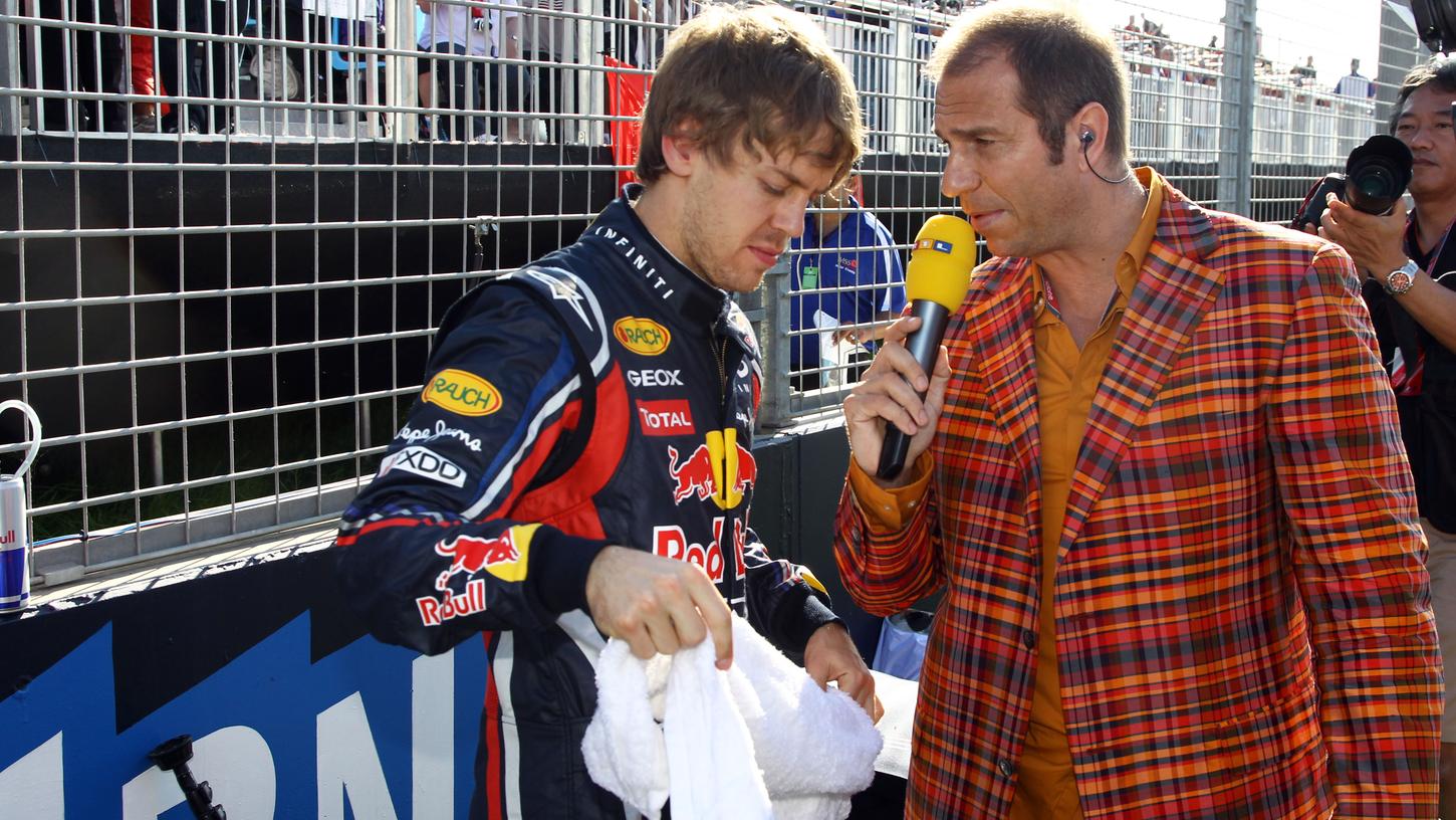 Immer mittendrin: RTL-Moderator Kai Ebel (rechts) in der Boxengasse mit Formel-1-Pilot Sebastian Vettel.