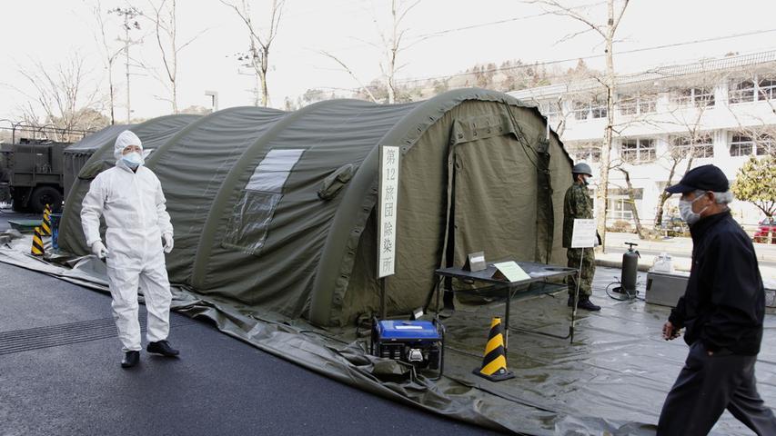In provisorischen Dekontaminierungsschleusen wie diesem Zelt untersucht man die Evakuierten auf eine mögliche Verstrahlung.