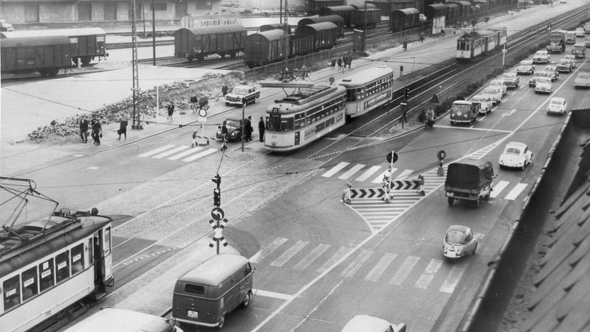 So sah es 1963 in der Fürther Straße aus, als die Straßenbahnen noch ebenerdig fahren durften. Wegen umfangreicher Umbauarbeiten an der Dooser Kreuzung im Zuge des Frankenschnellwegbaus, war zu diesem Zeitpunkt eine längerfristige Umleitung für den Pkw-Verkehr eingerichtet worden. Hier ist der Abschnitt in Höhe der Einmündung zur Ferdinandstraße zu sehen (Blickrichtung Fürth). Heute erhebt sich an dieser Stelle die Hochbahntrasse.