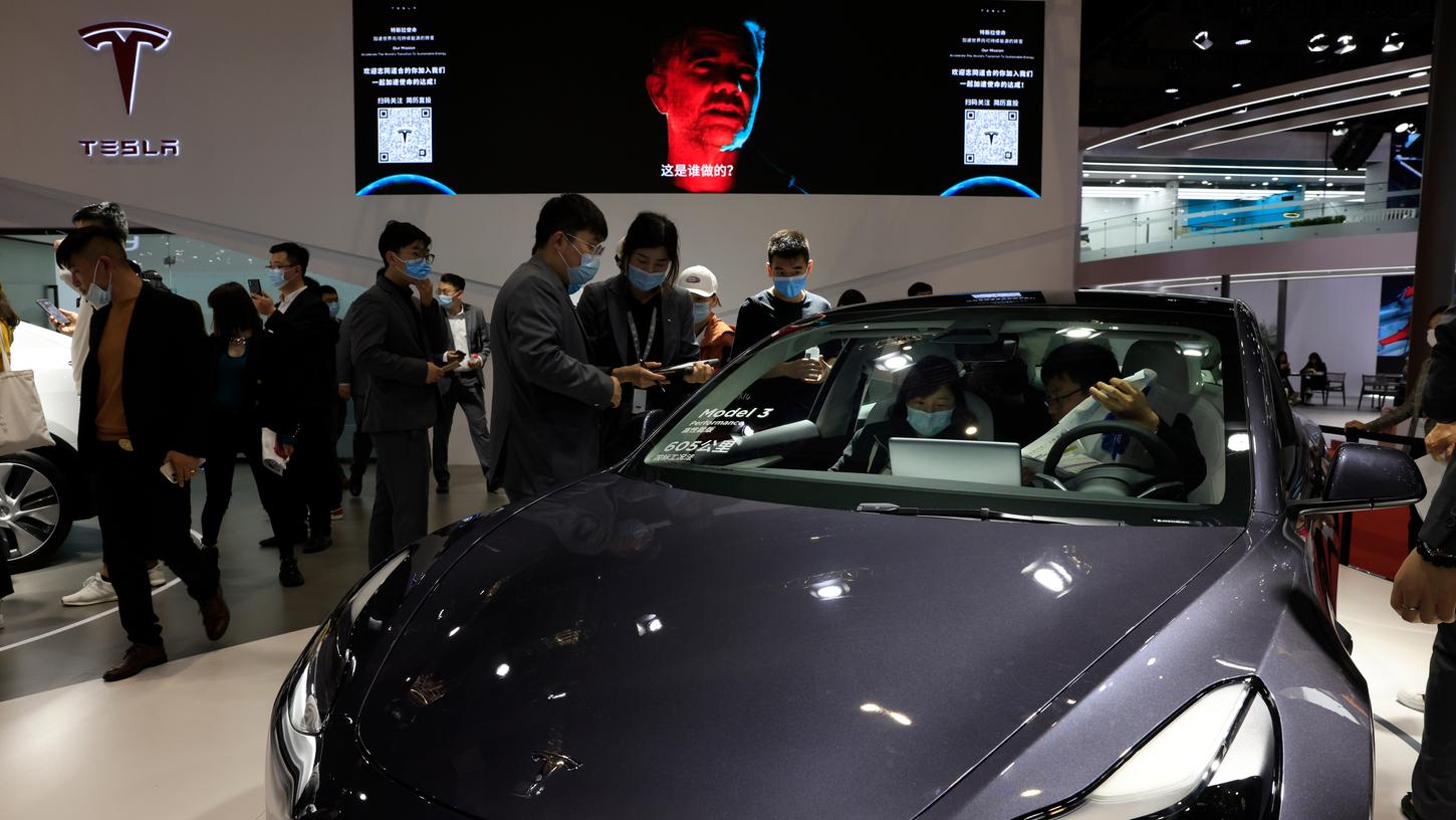 Besucher sehen sich ein Tesla Model 3 auf der internationalen Automesse «Auto Shanghai 2021» an.