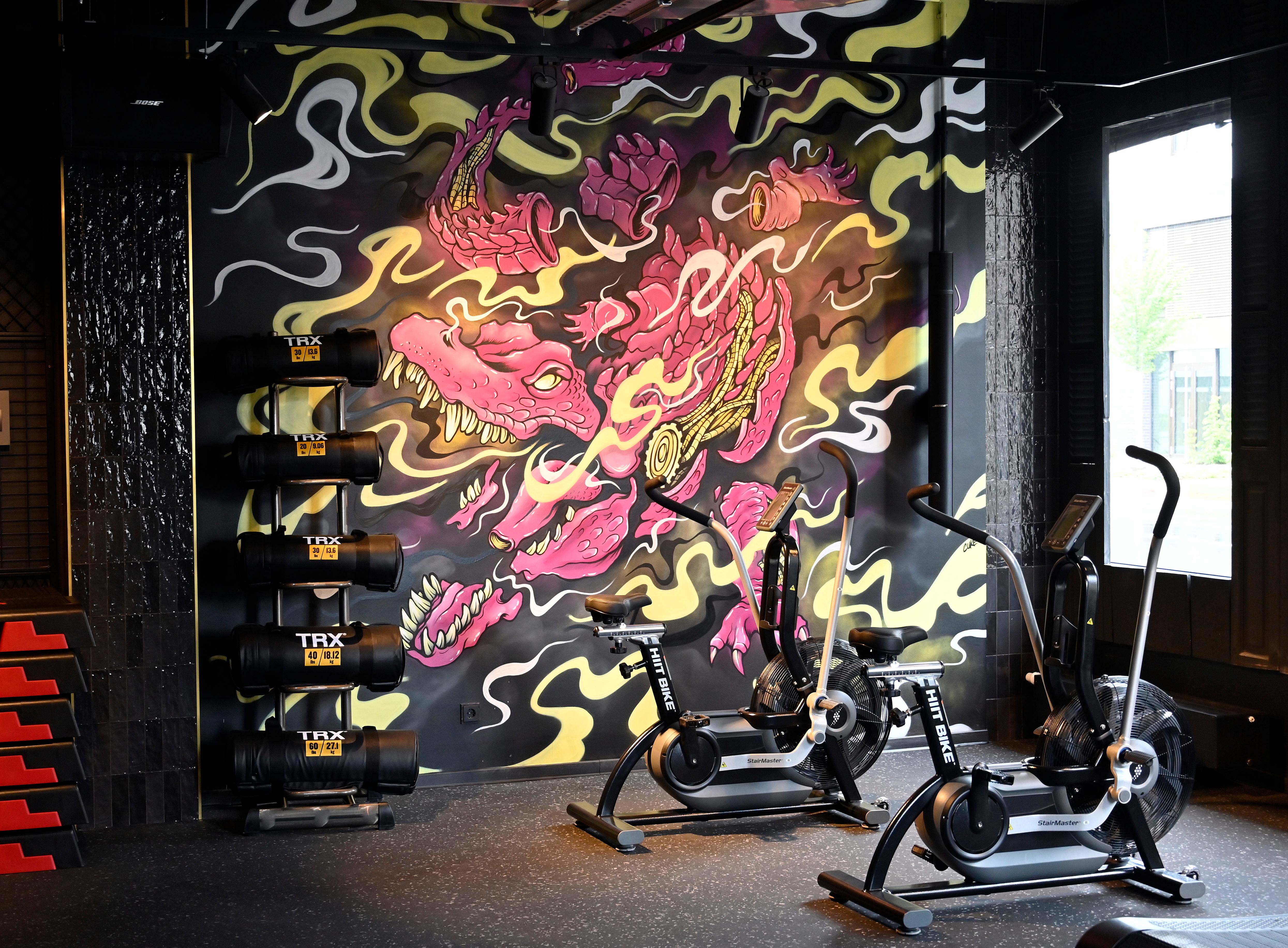 Der John Reed Fitness Music Club in der Erlanger Nägelsbachstraße ist die Edel-Variante von MCFit, beide Marken gehören zum Unternehmen der RSG Group. Im Vergleich zur nur halb so teuren Schwester bietet das "John Reed"-Studio unter anderem einen großen Wellnessbereich, Kinderbetreuung, Streetart an den Wänden, zweimal die Woche Live-DJs und - auf Zubuchung - individuelles, geleitetes Training.