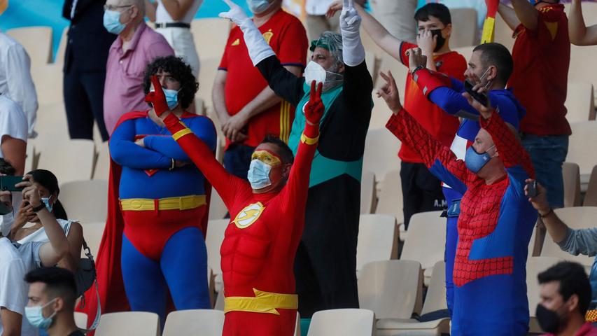 Spain's fans dressed as super-heroes like Flash Gordon, Superman or Spiderman gesture before the UEFA EURO 2020 Group E football match between Spain and Sweden at La Cartuja Stadium in Sevilla on June 14, 2021. (Photo by Jose Manuel Vidal / POOL / AFP)