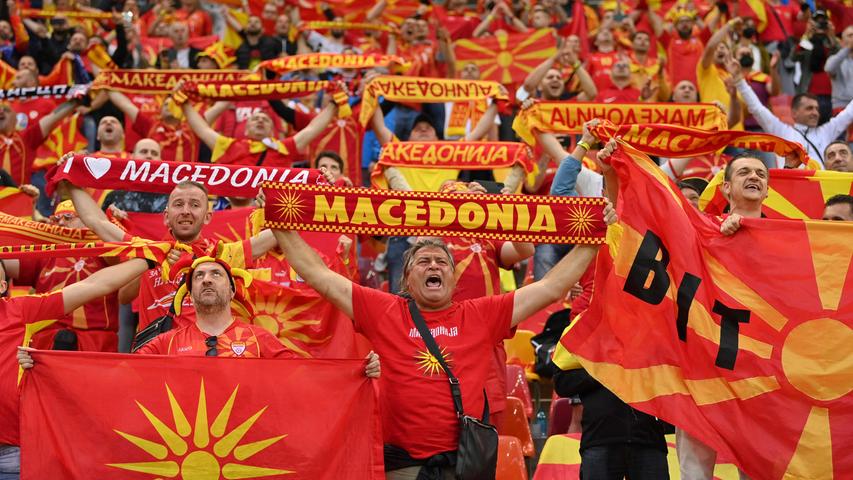 TOPSHOT - North Macedonia fans cheer for their team during the UEFA EURO 2020 Group C football match between Austria and North Macedonia at the National Arena in Bucharest on June 13, 2021. (Photo by Justin Setterfield / POOL / AFP)