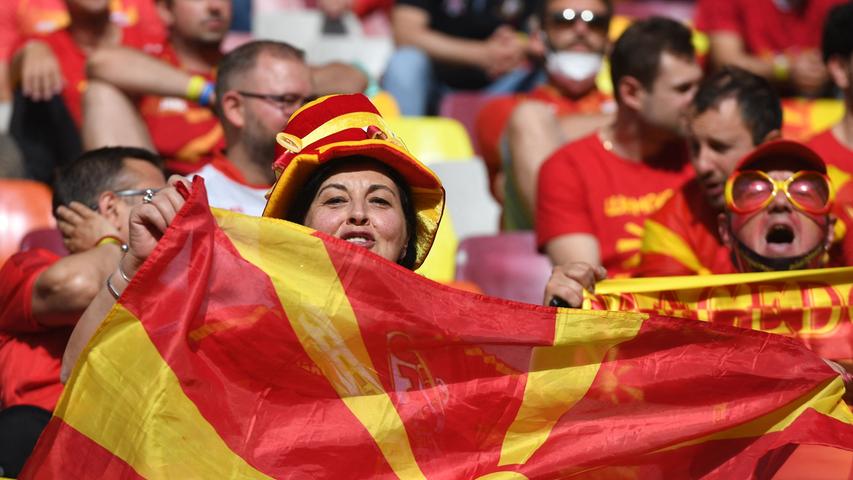 A North Macedonia fan cheers for her team before the UEFA EURO 2020 Group C football match between Austria and North Macedonia at the National Arena in Bucharest on June 13, 2021. (Photo by Daniel MIHAILESCU / POOL / AFP)