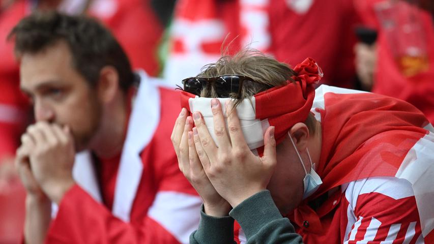 Fans react after Denmark's midfielder Christian Eriksen collapsed during the UEFA EURO 2020 Group B football match between Denmark and Finland at the Parken Stadium in Copenhagen on June 12, 2021. (Photo by Jonathan NACKSTRAND / POOL / AFP)