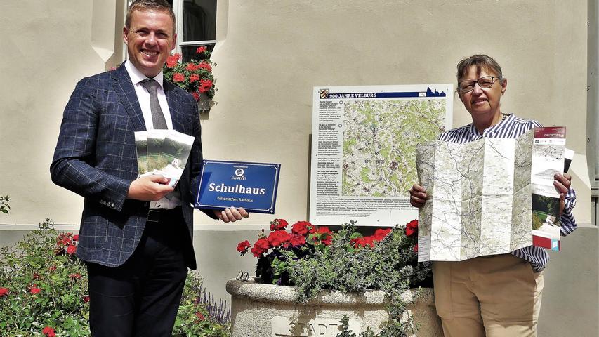 In Velburg haben Bürgermeister Christian Schmid und seine für den Tourismus zuständige Mitarbeiterin Petra Dürr jetzt vor dem historischen Rathaus die ersten Schilder mit alten Hausnamen sowie die neue Velburger Wanderkarte präsentiert.