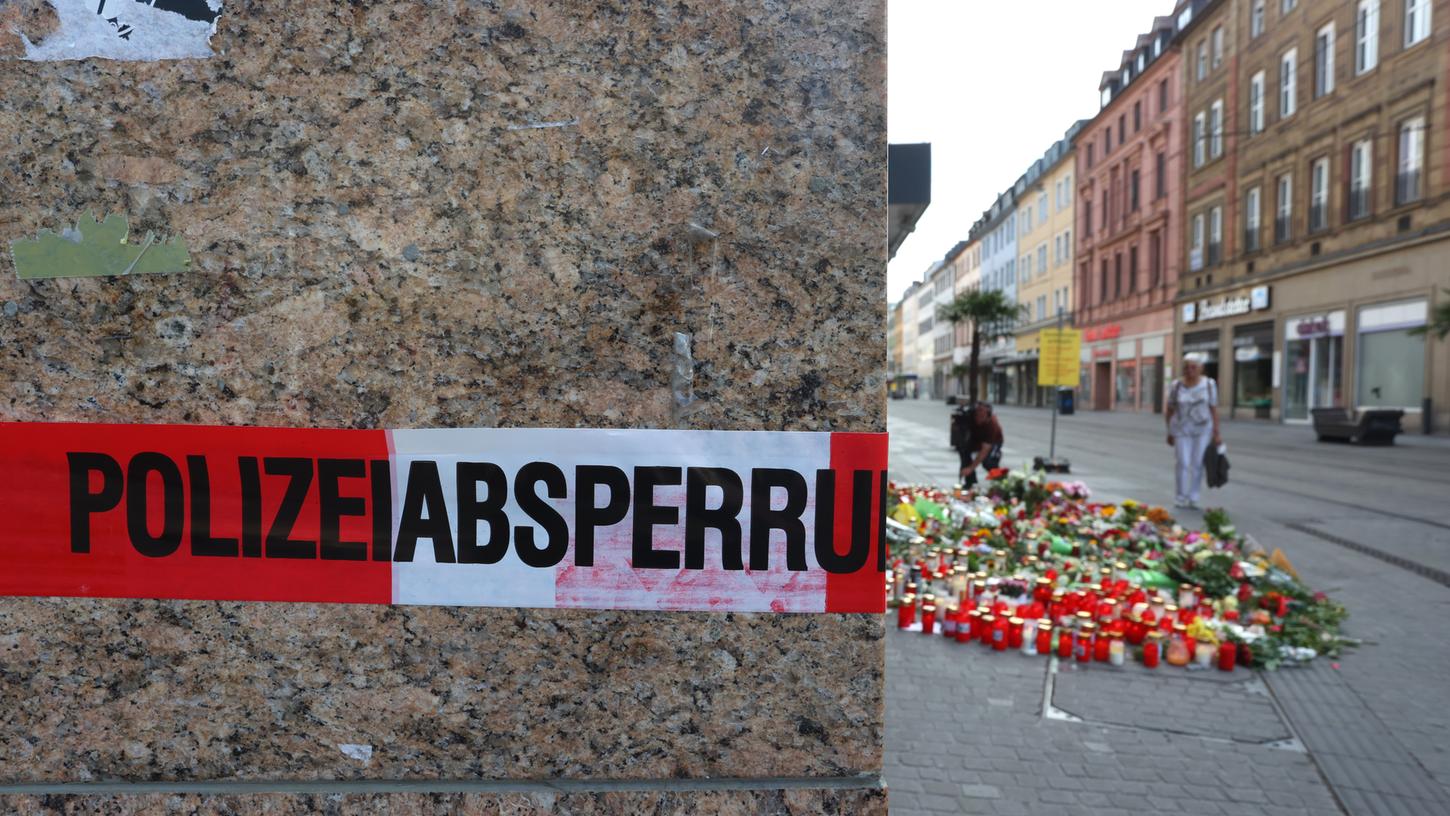 Auch am Tag nach der Tat ist das das Kaufhaus, in dem der Somalier mehrere Menschen angriff, noch abgesperrt. Dahinter haben Trauernde Kerzen und Blumen abgelegt.
Auch am Tag nach der Tat ist das das Kaufhaus, in dem der Somalier mehrere Menschen angriff, noch abgesperrt. Dahinter haben Trauernde Kerzen und Blumen abgelegt.