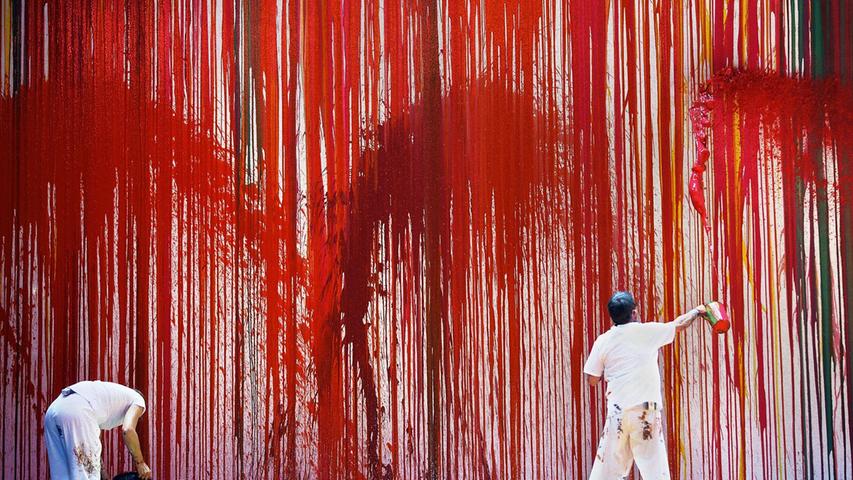 Zu Wotans Feuerzauber werden rote Farbfontänen gegen die Wand geschleudert.
Zu Wotans Feuerzauber werden rote Farbfontänen gegen die Wand geschleudert.