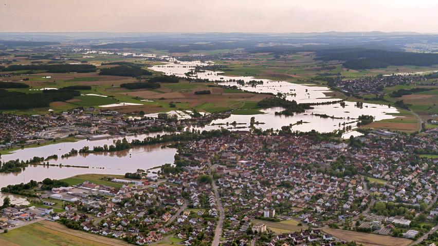 Das Aisch-Hochwasser vom Wochenende um den 10. Juli 2021 war ein Jahrhundert-Hochwasser, an manchen Stellen lagen die Fluten sogar leicht über dieser Marke. Hier erstreckt sich der Blick aus der Luft in Richtung Westen auf Höchstadt/Aisch.