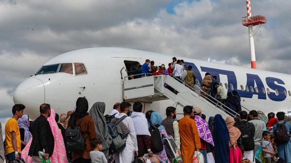 STYLELOCATIONAfghan refugees board a Atlas Air commercial aircraft for transfer to the United States after evacuation fr