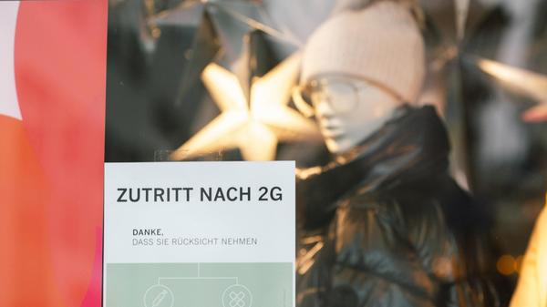 Daily Life In Bonn Amid The Covid-19 Pandemic 2G sign is seen on the window of AppelrathCuepper, a clothing retailer st