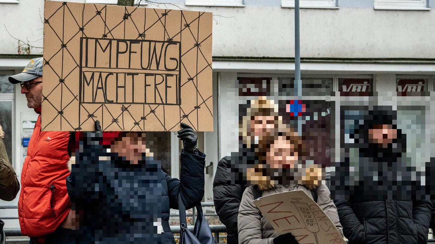 Impfgegner haben am Sonntag in Nürnberg protestiert. Am Rande der AfD-Kundgebung hielt eine Frau ein Schild mit der Aufschrift "Impfung macht frei" hoch.
