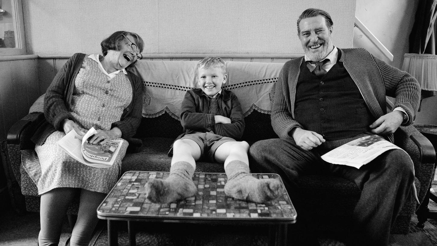 Spaß mit den Großeltern: Judi Dench (links) als Granny, Jude Hill (Mitte) als Buddy und Ciarán Hinds als Pop in einer Szene des Films "Belfast". Spaß mit den Großeltern: Judi Dench (links) als Granny, Jude Hill (Mitte) als Buddy und Ciarán Hinds als Pop in einer Szene des Films "Belfast".