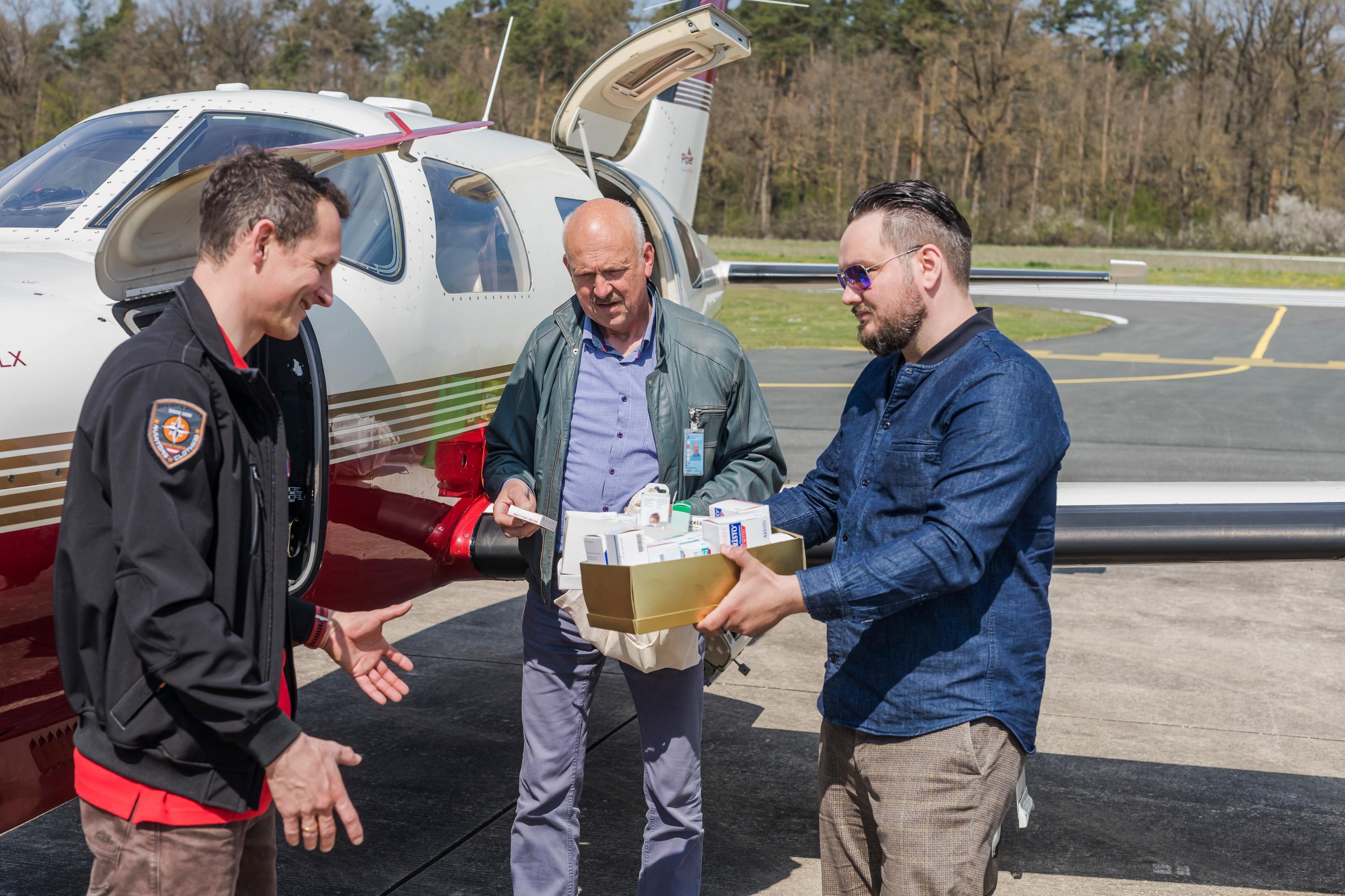 Der Arzt Falk Stirkat und zwei Piloten bringen die Hilfsware an Bord der Cessna. 