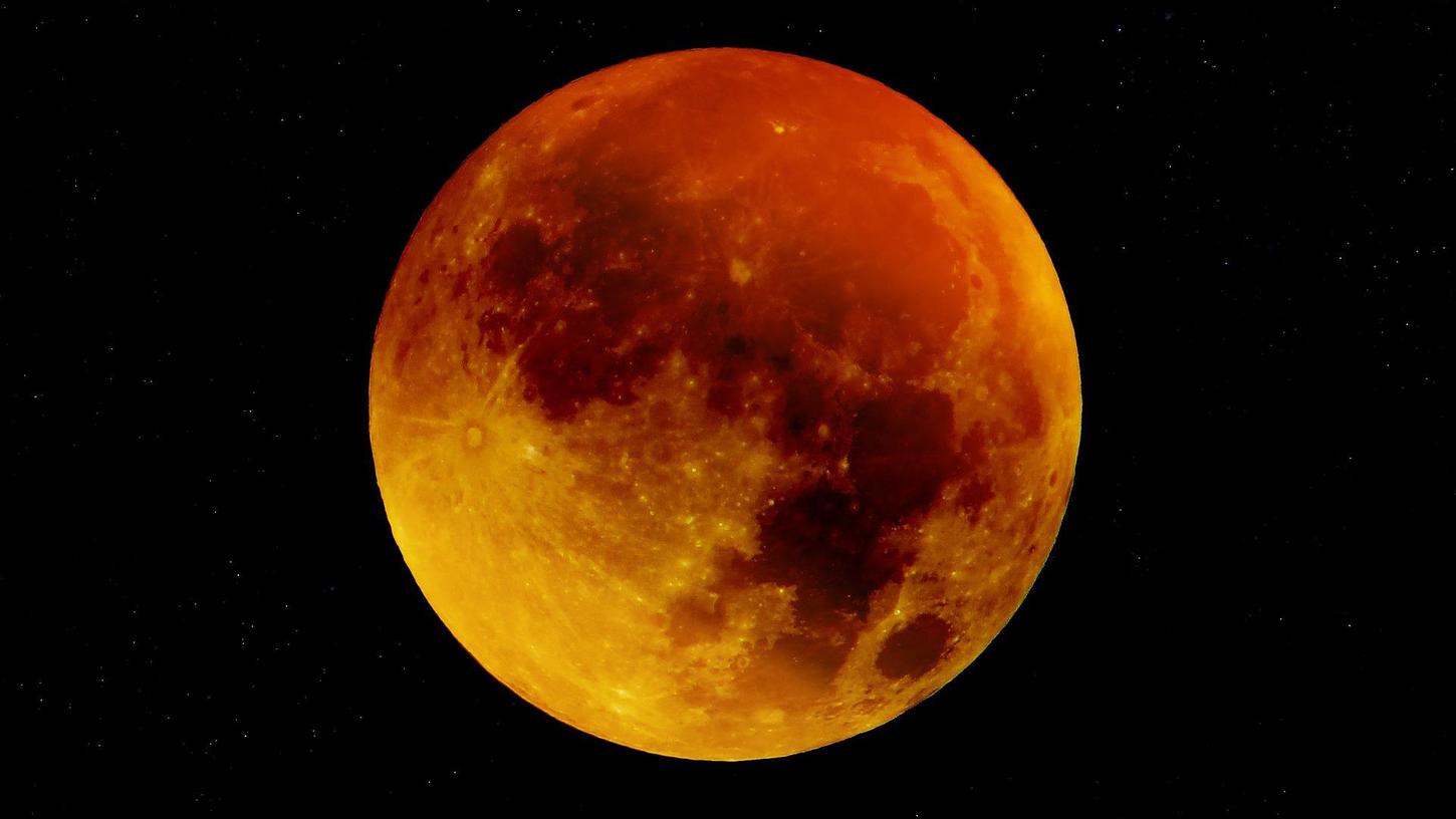 Der Mond erscheint während einer totalen Mondfinsternis rötlich. 