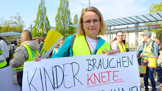 Christina Merz mit ihrem Banner: "Kinder brauchen Knete, Erzieherinnen auch."
