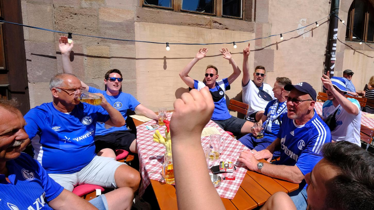 Stimmen sich ausgelassen und bester Laune auf die Partie gegen den 1FCN morgen im Stadion ein: Schalke-Fans auf der Terrasse des "Spießgesellen". 