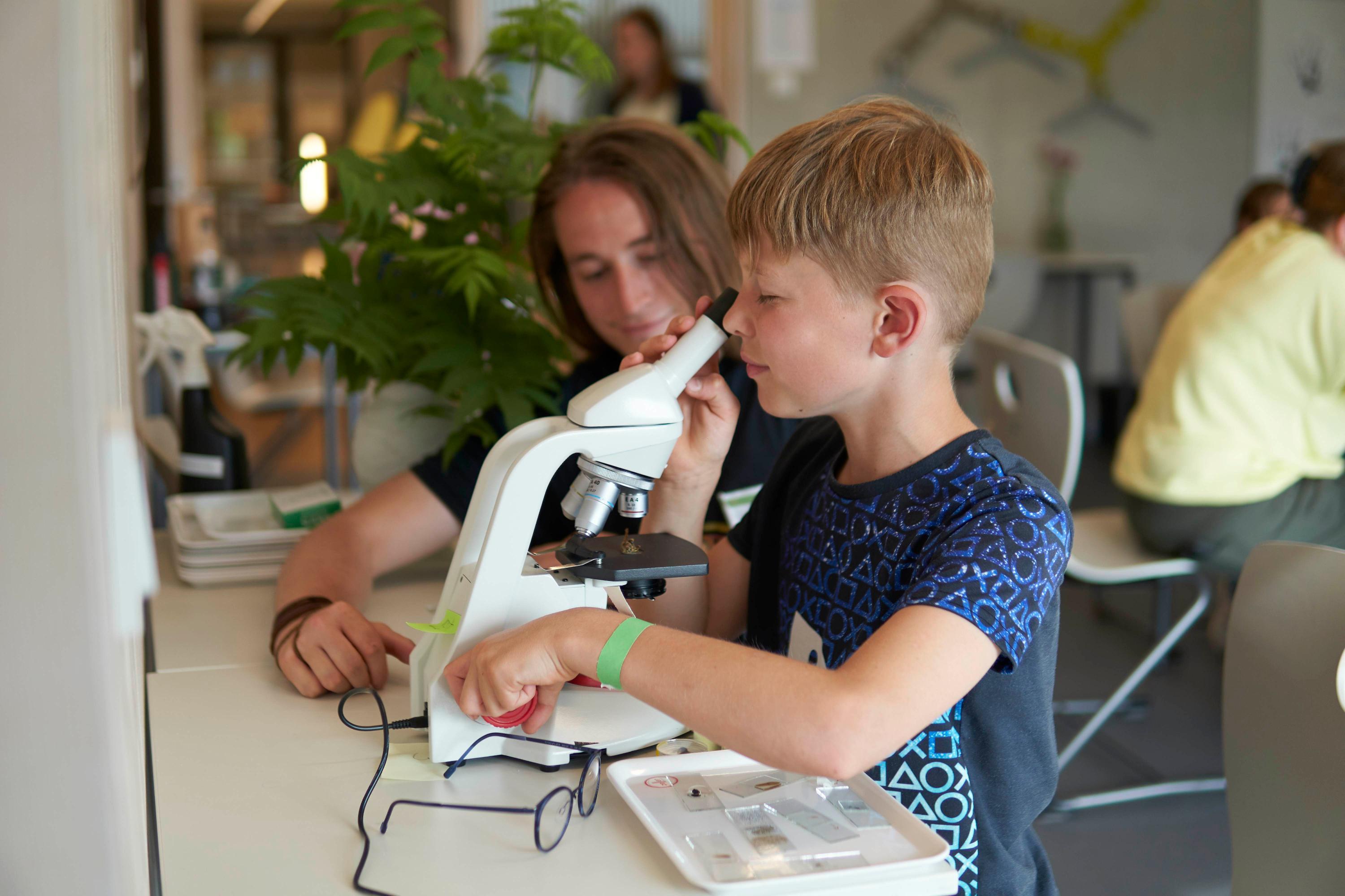 Auch Leon (9) sah sich die unterschiedlichsten Dinge unterm Mikroskop an: Insekten, Müsli, Salz... Was war am tollsten? "Alles war cool!",  sagt er strahlend. Student Niklas Hartlieb zeigte ihm, was man im Detail alles bestaunen kann.