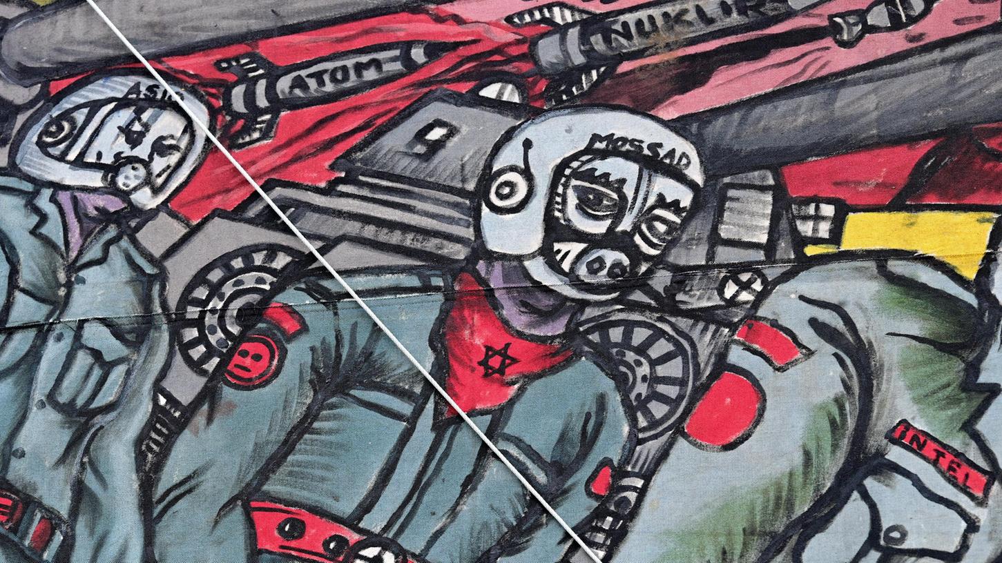 Der Ausschnitt des umstrittenen Großgemäldes des indonesischen Künstlerkollektivs Taring Padi auf dem Friedrichsplatz zeigt einen Soldaten mit Schweinsgesicht. Er trägt ein Halstuch mit einem Davidstern und einen Helm mit der Aufschrift «Mossad», der Bezeichnung des israelischen Auslandsgeheimdienstes. 