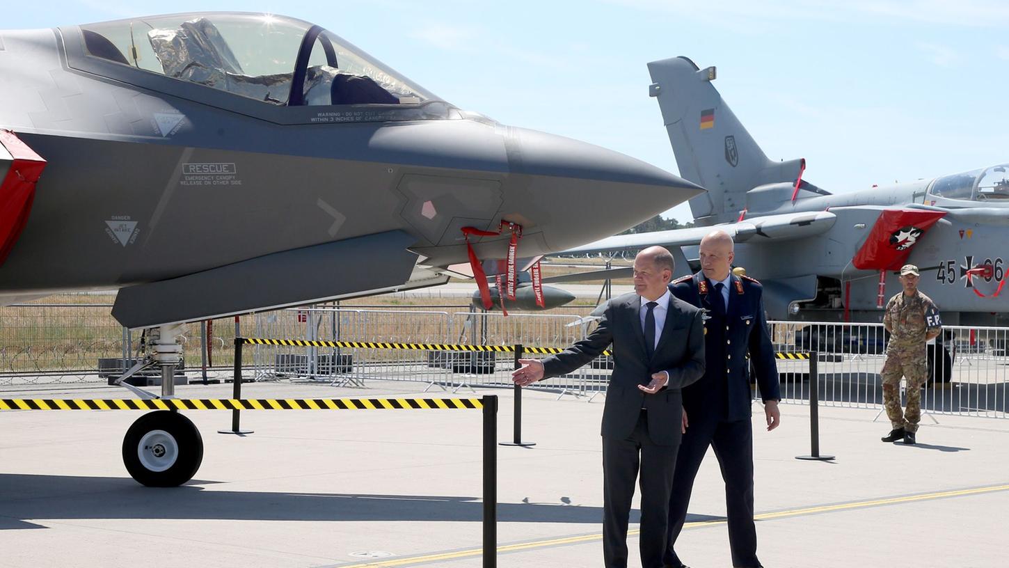 Bundeskanzler Olaf Scholz (SPD) steht neben Generalleutnant Ingo Gerhartz (r), Inspekteur der Luftwaffe, vor einem F-35 Tarnkappenjet auf der Internationalen Luft- und Raumfahrtausstellung (ILA).