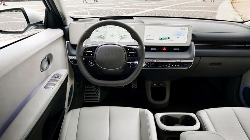 Vor dem Fahrer erstreckt sich ein weißes Panel, das zwei Bildschirme integriert, einen für die fahrrelevanten Informationen und einen Touchscreen fürs Infotainment.