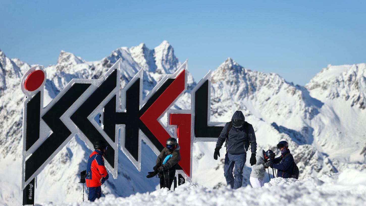 Wintersportler stehen vor dem Ischgl-Schriftzug.