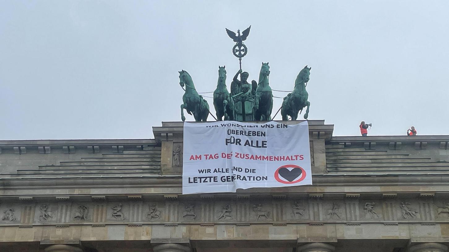 Aktivisten von "Letzte Generation" haben das Brandenburger Tor besetzt und ein Banner von der Quadriga entrollt.