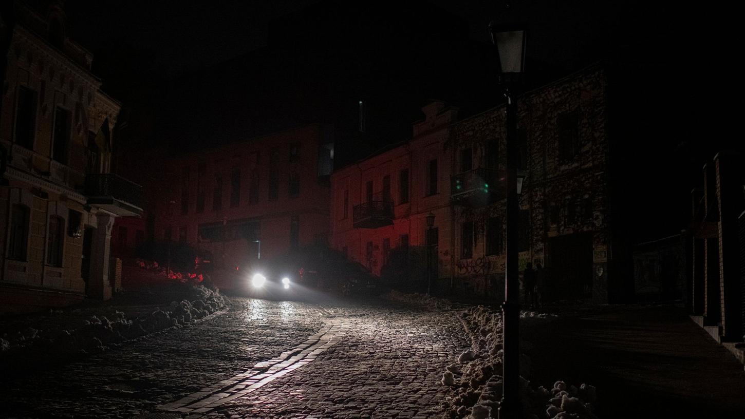 Ein Fahrzeug fährt während eines Stromausfalls nach einem russischen Raketenangriff.