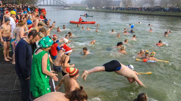 Bei einer Wassertemperatur von 4,5 Grad Celsius stürzen hier rund 200 Schwimmer beim traditionellen Neujahrsschwimmen im nordrhein-westfälischen Münster in den Dortmund-Ems-Kanal.