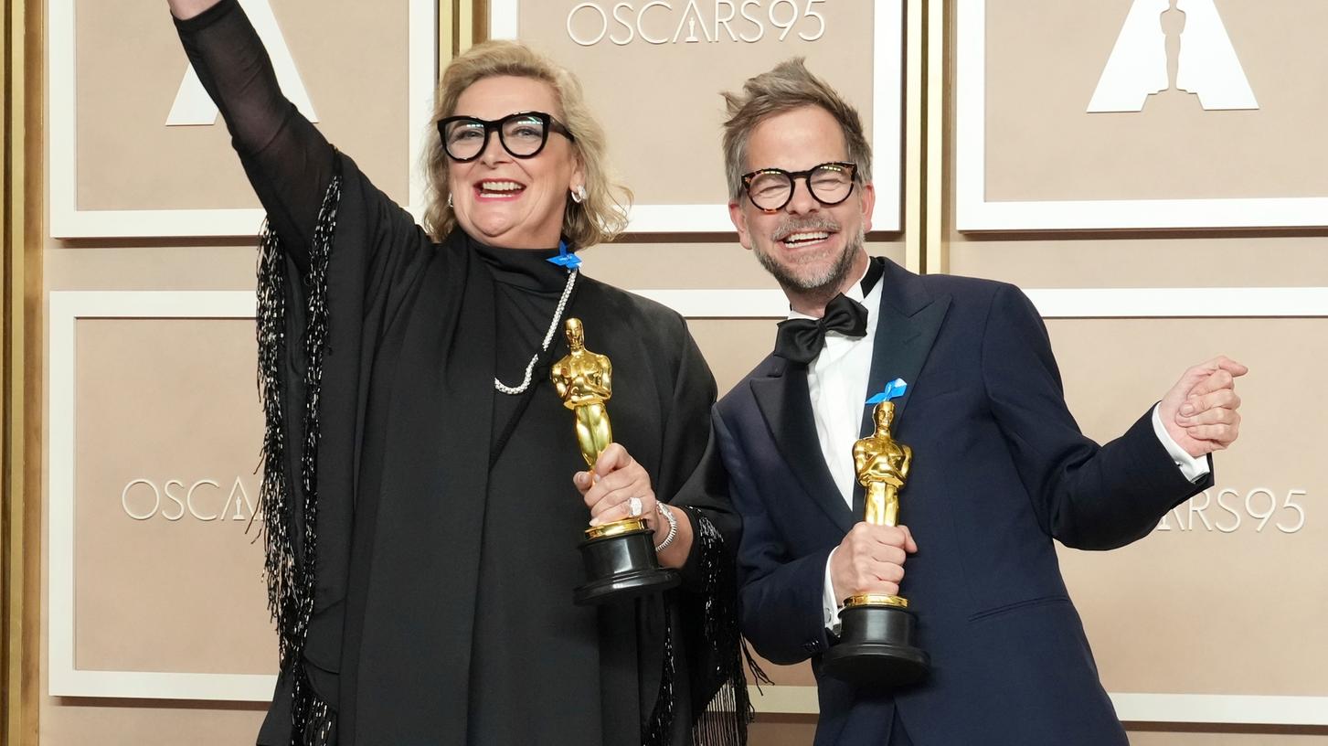 Ernestine Hipper und Christian M. Goldbeck, Gewinner des Preises für das beste Produktionsdesign für "Im Westen nichts Neues" jubeln im Presseraum der Oscar-Verleihung im Dolby Theatre. 