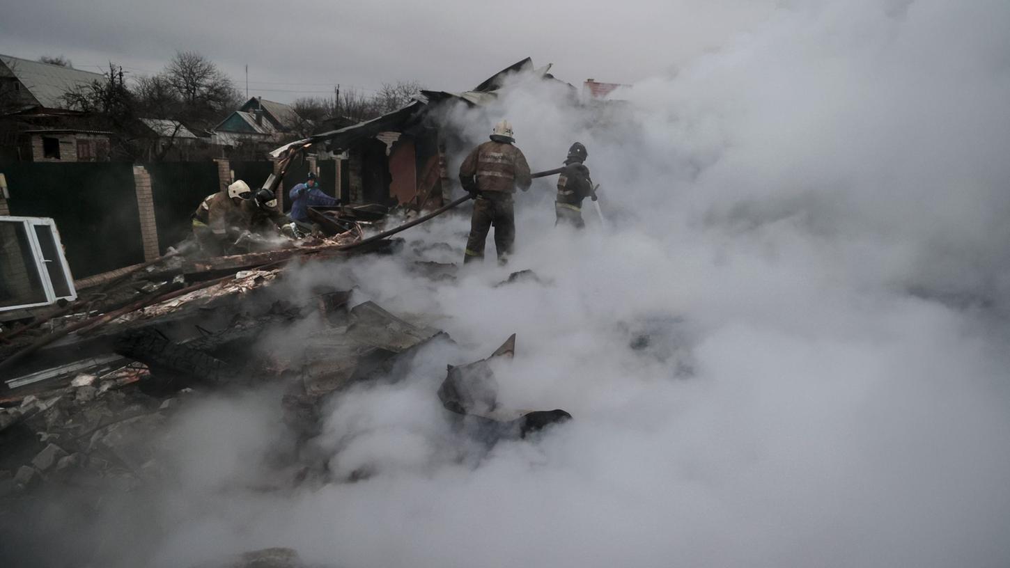 Feuerwehrleute löschen ein Feuer nach Beschuss im ukrainischen Charzysk. Feuerwehrleute löschen ein Feuer nach Beschuss im ukrainischen Charzysk.