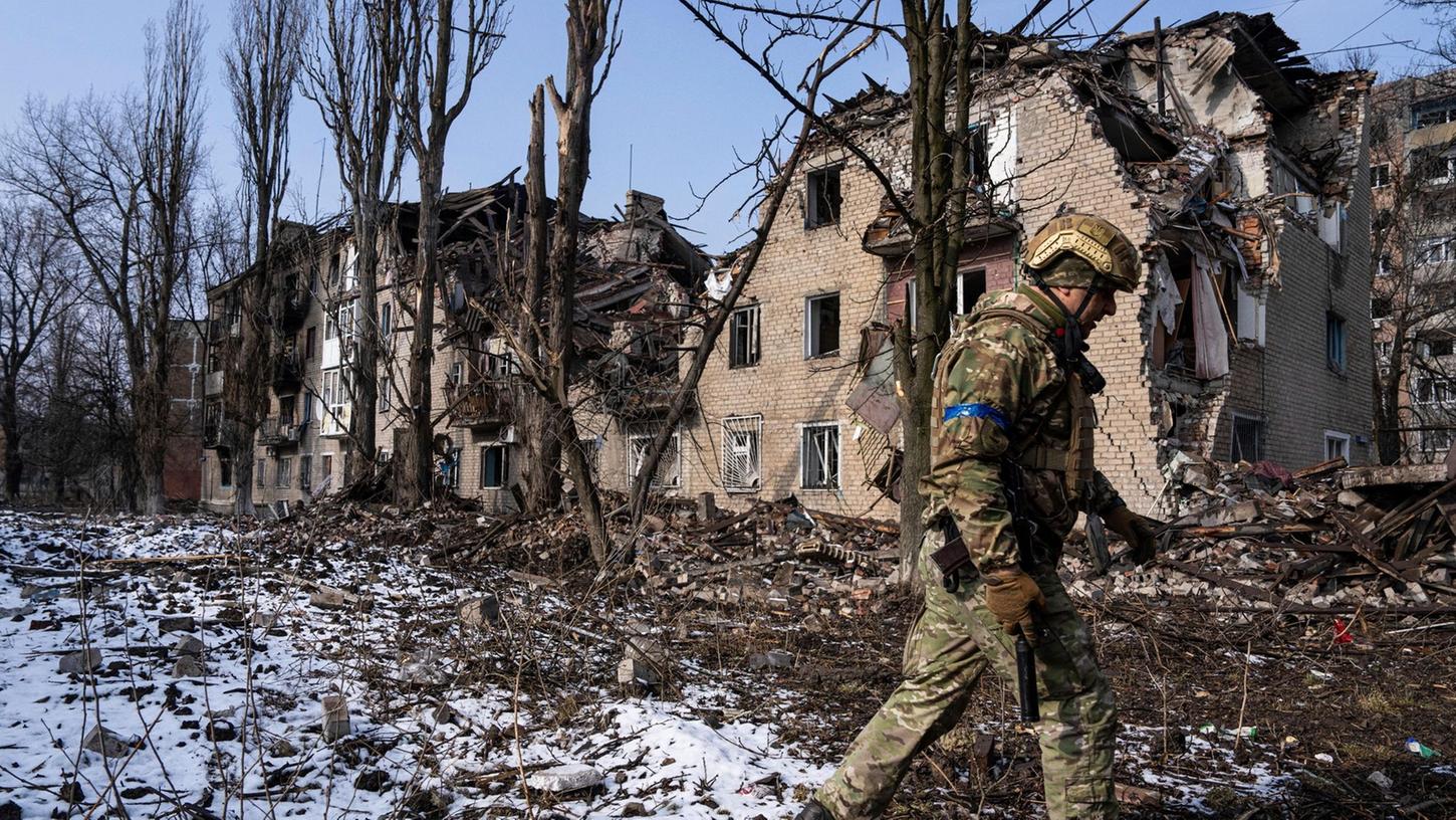 Ein ukrainischer Soldat vor einem zerstörten Wohnhaus in der ostukrainischen Stadt Awdijiwka.