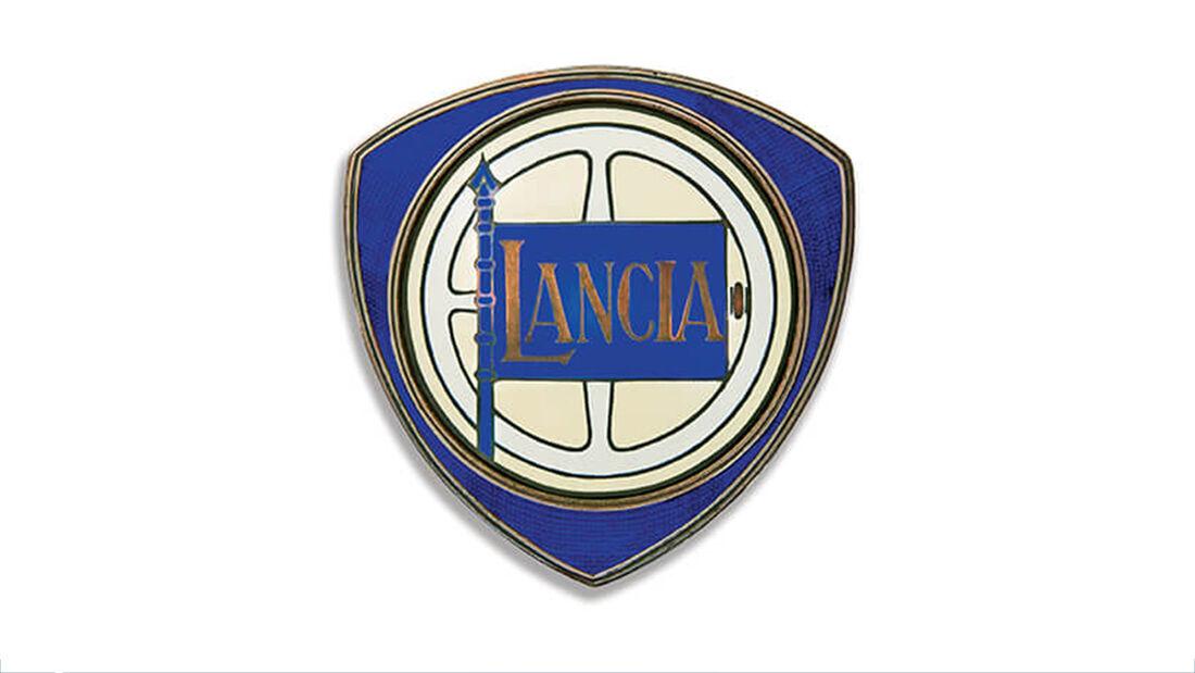 Schon damals mit Lenkrad, Lanze und Flagge auf dreieckigem Schild: Lancia-Logo aus dem Jahr 1929.