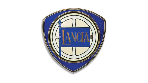 Schon damals mit Lenkrad, Lanze und Flagge auf dreieckigem Schild: Lancia-Logo aus dem Jahr 1929.