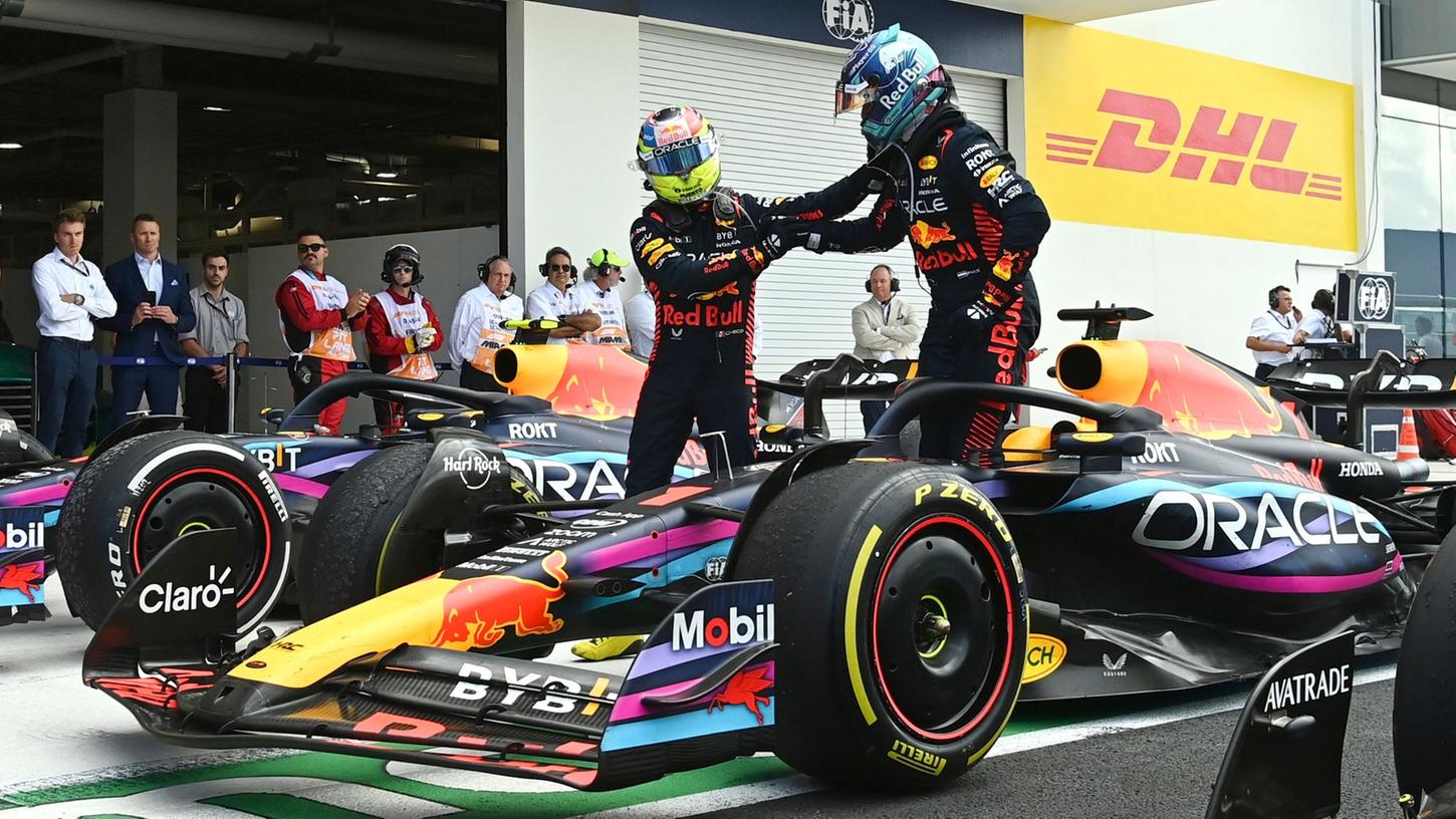 Red-Bull-Pilot Sergio Pérez (l) gratuliert seinem Teamkollegen Max Verstappen zum Sieg.