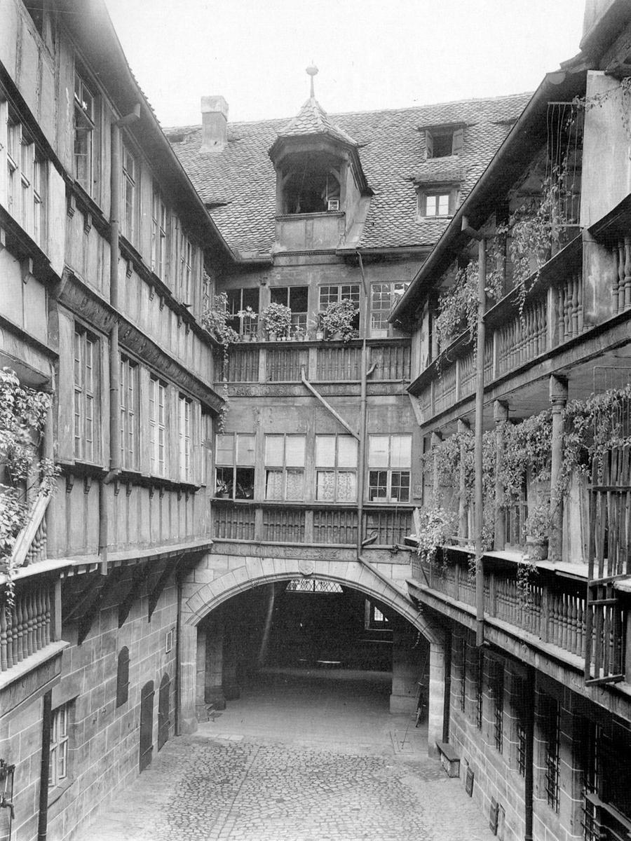Der Blick vom Flügel am Brunnengäßchen, aufgenommen um 1910, zeigt den malerischen Innenhof des Scheurl’schen Anwesens mit seinen umlaufenden Galerien.  