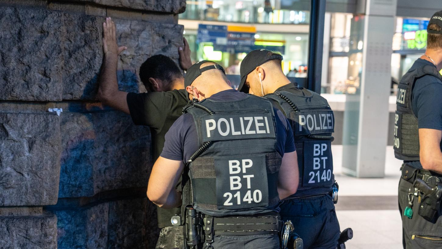 Dieses Foto zeigt, wie Polizisten einen Verdächtigen am Hauptbahnhof während der Schwerpunktaktion kontrollieren. 