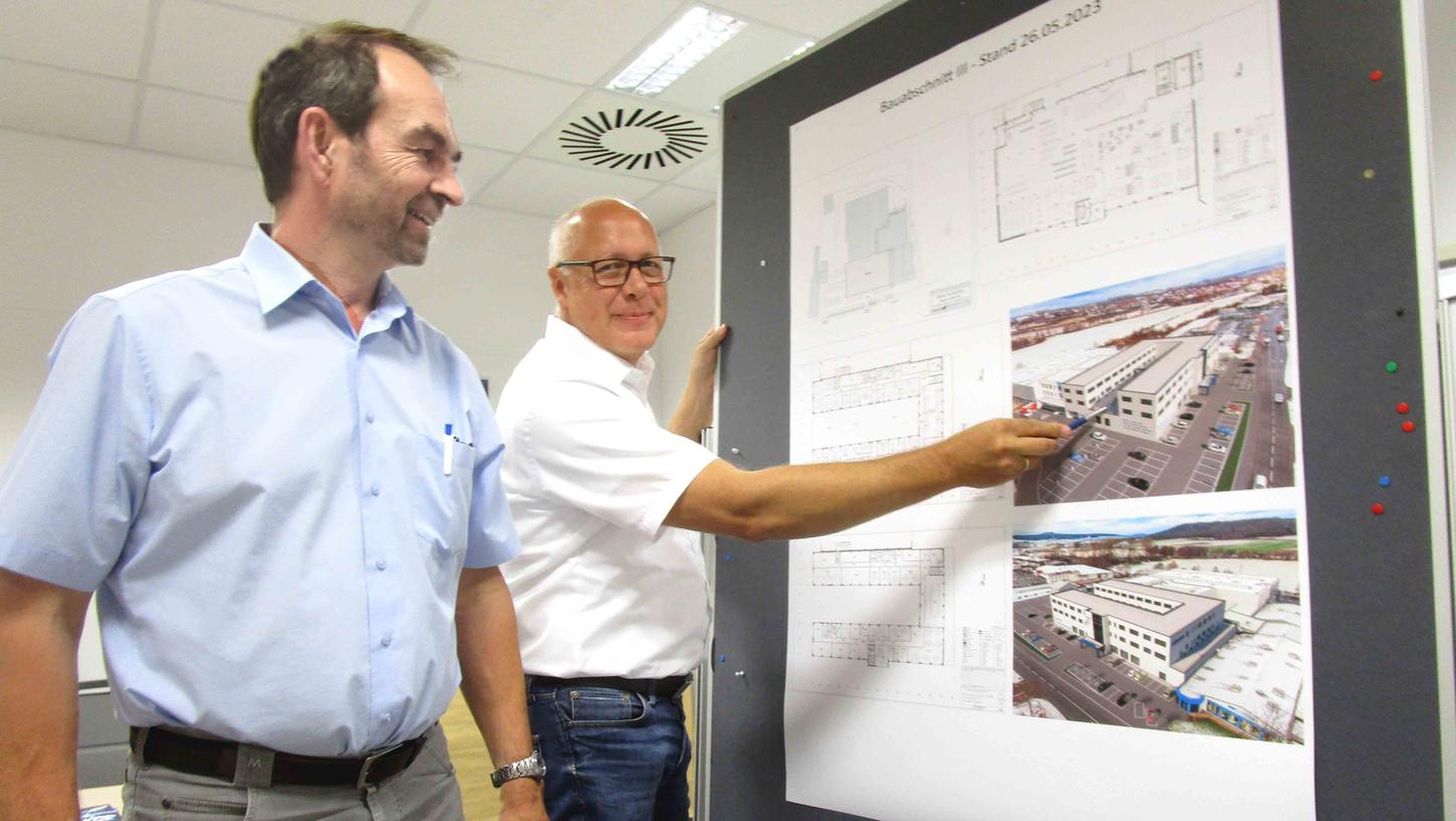 Dr. Norbert Teltschik (links) und Projektleiter Karl Vogel präsentieren die Pläne für den „Kopfbau“, der auf der Größe eines Fußballfeldes entsteht. Ausstellungsflächen, Verkaufsräume sowie Büros, Schulungs- und Aufenthaltsräume sind auf kurze Wege und beste Arbeitsbedingungen ausgerichtet. Dr. Norbert Teltschik (links) und Projektleiter Karl Vogel präsentieren die Pläne für den „Kopfbau“, der auf der Größe eines Fußballfeldes entsteht. Ausstellungsflächen, Verkaufsräume sowie Büros, Schulungs- und Aufenthaltsräume sind auf kurze Wege und beste Arbeitsbedingungen ausgerichtet.