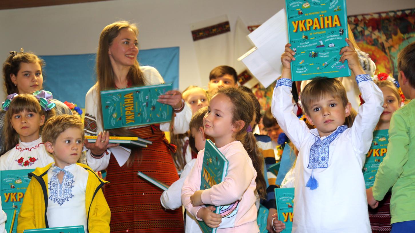 Schulkoordinatorin Liuba Tkachuk feiert mit Kindern der Samstagsschule das Fest der ukrainischen Tracht, zu dem alle Kinder ein Buch geschenkt bekommen haben. Schulkoordinatorin Liuba Tkachuk feiert mit Kindern der Samstagsschule das Fest der ukrainischen Tracht, zu dem alle Kinder ein Buch geschenkt bekommen haben.
