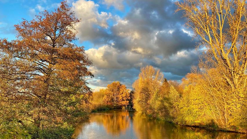Am Erlanger Wöhrmühlsteg zeigt sich der Herbst von seiner schönsten Seite und hüllt die Regnitz in goldene Farben. Mehr Leserfotos finden Sie hier