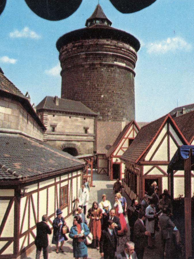 Retro-Idylle pur: Hinter der Budenstadt des Handwerkerhofs ragen um 1977 die Stadtmauer und der mächtige Frauentorturm auf.