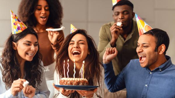 Diverse friends united in birthday celebration enjoying party together indoors