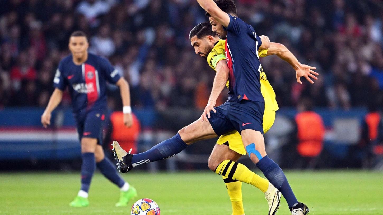 Dortmunds Emre Can und Goncalo Ramos (vorne) von Paris kämpfen um den Ball.