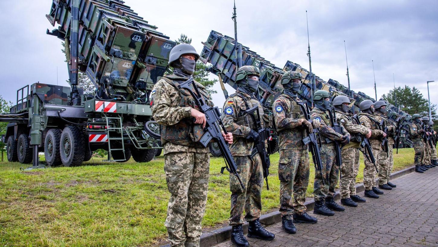 Ukrainische und deutsche Soldaten stehen bei der Ausbildung am Flugabwehrraketensystem "Patriot" auf einem Truppenübungsplatz.