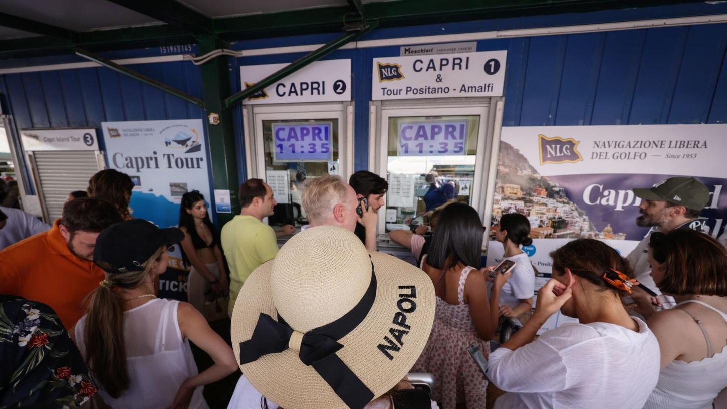 Reisende drängen sich vor Ticket-Schaltern am Molo Beverello für die Fähren, die unter anderem nach Capri fahren. Touristen dürfen nun wieder auf die Insel.